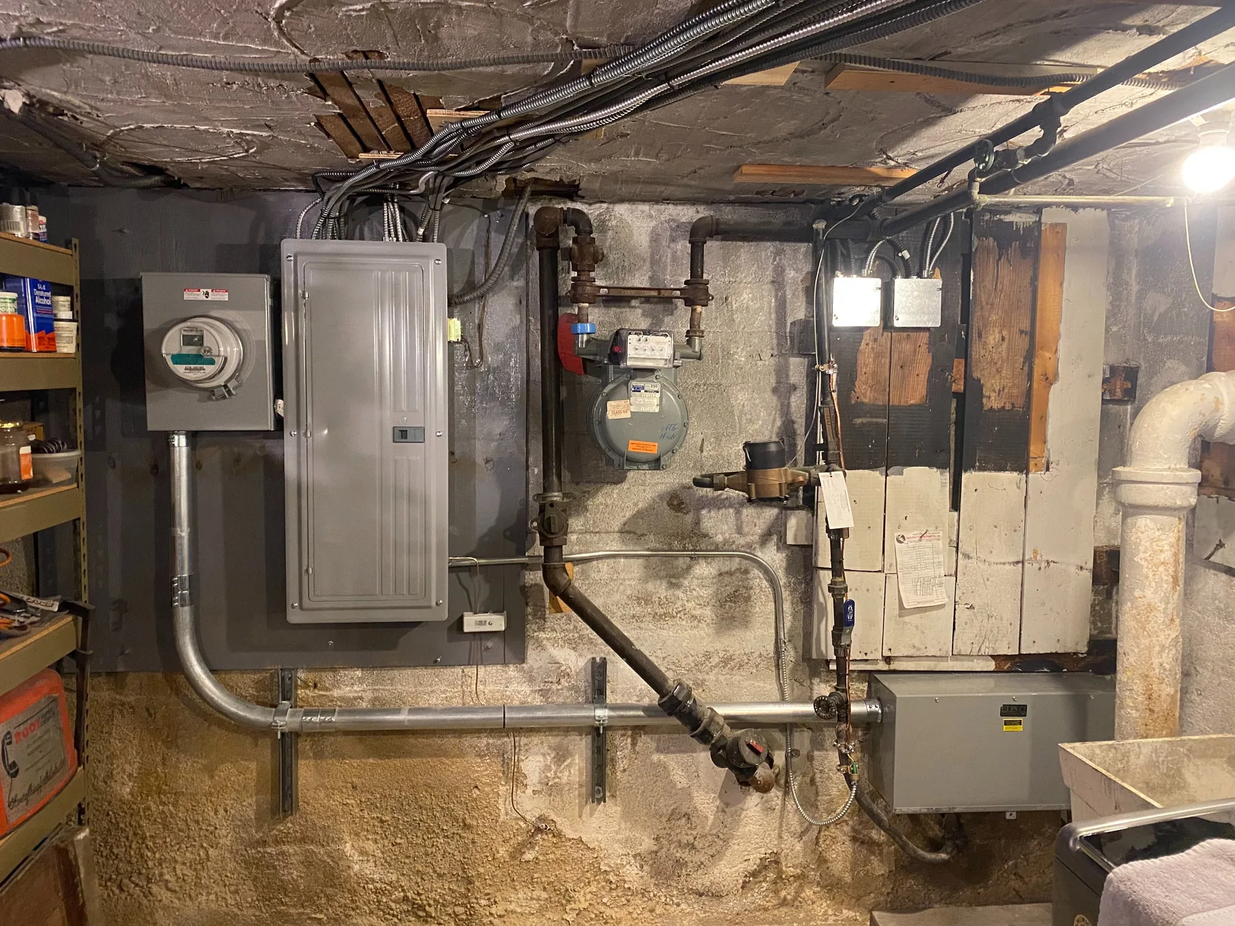 A basement panel and meter with conduit run to the service entrance