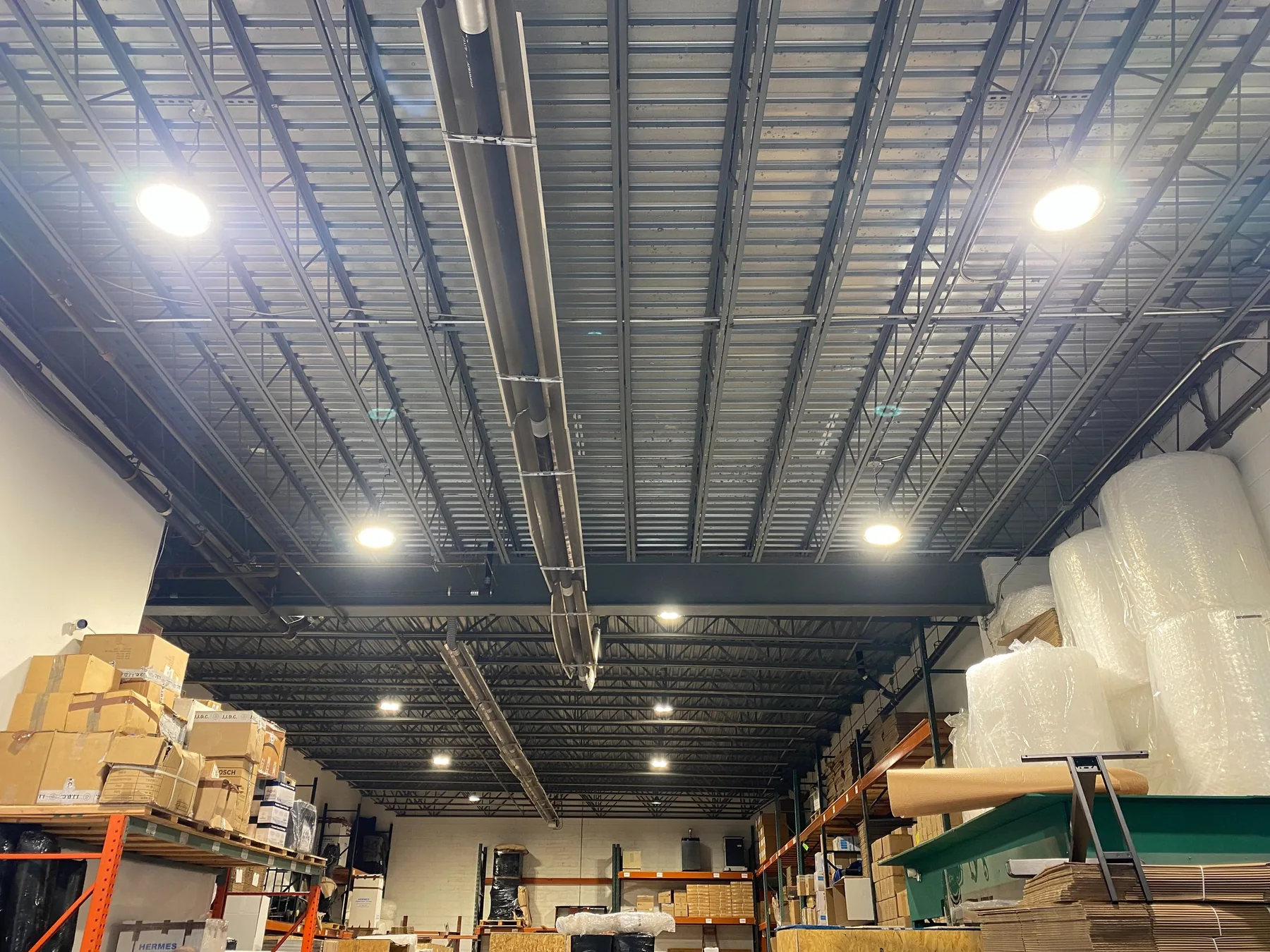 A warehouse interior lit evenly by new high-bay LED fixtures