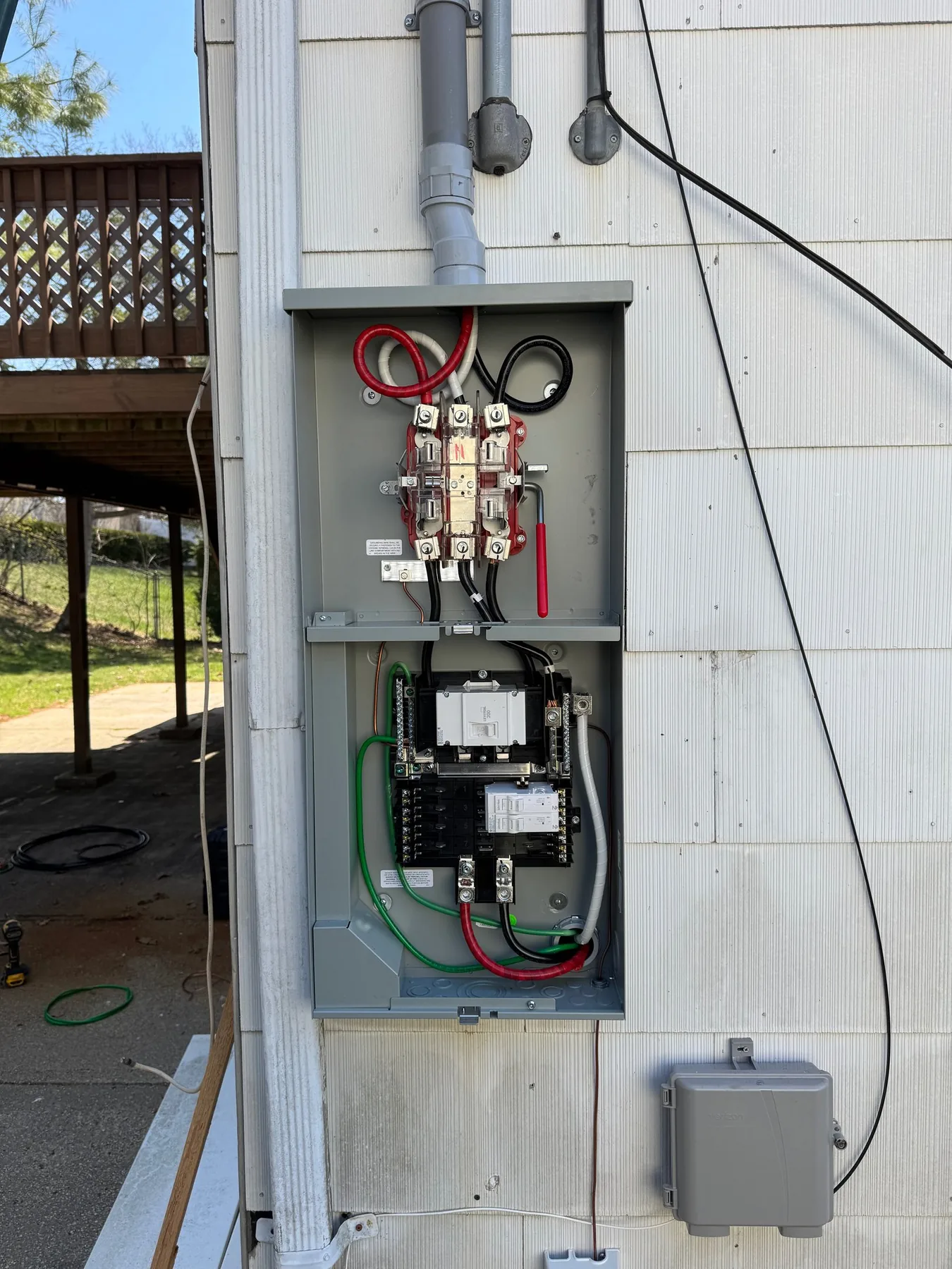 An outdoor electrical disconnect enclosure mounted on an exterior wall