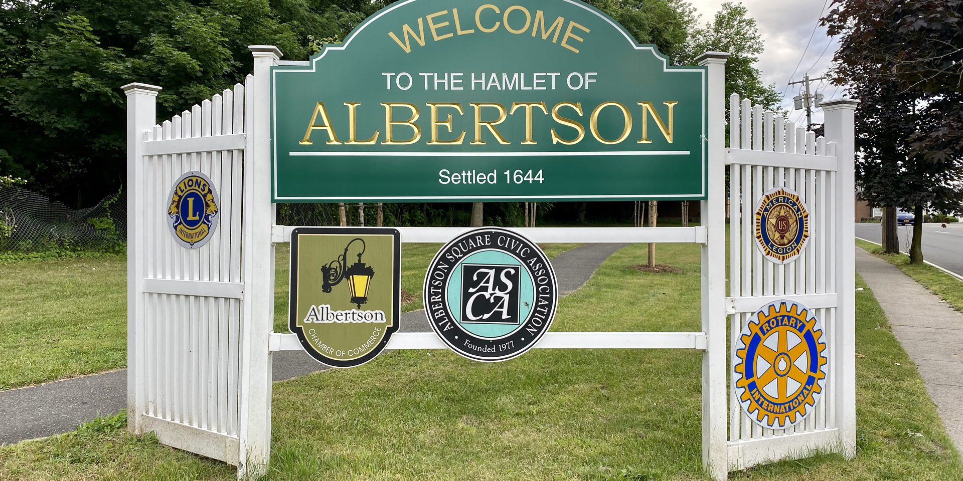 A Welcome Sign to Albertson on Willis Avenue in Albertson, Long Island, New York. This photo was taken on June 12, 2021