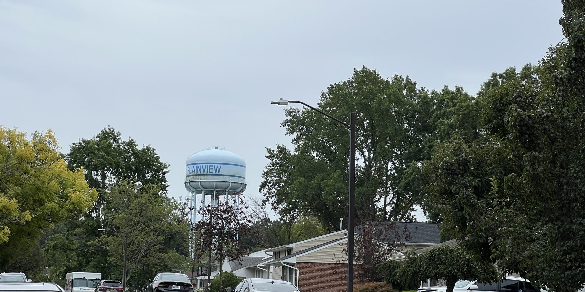 A residential street in Plainview, NY on September 11, 2022. The Plainview Water Tower is visible in the background